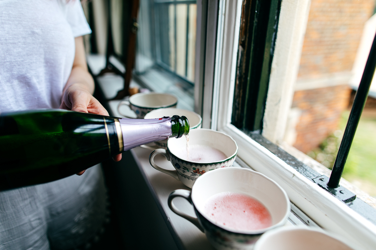 champagne-pouring-into-teacups-london-wedding-photographer