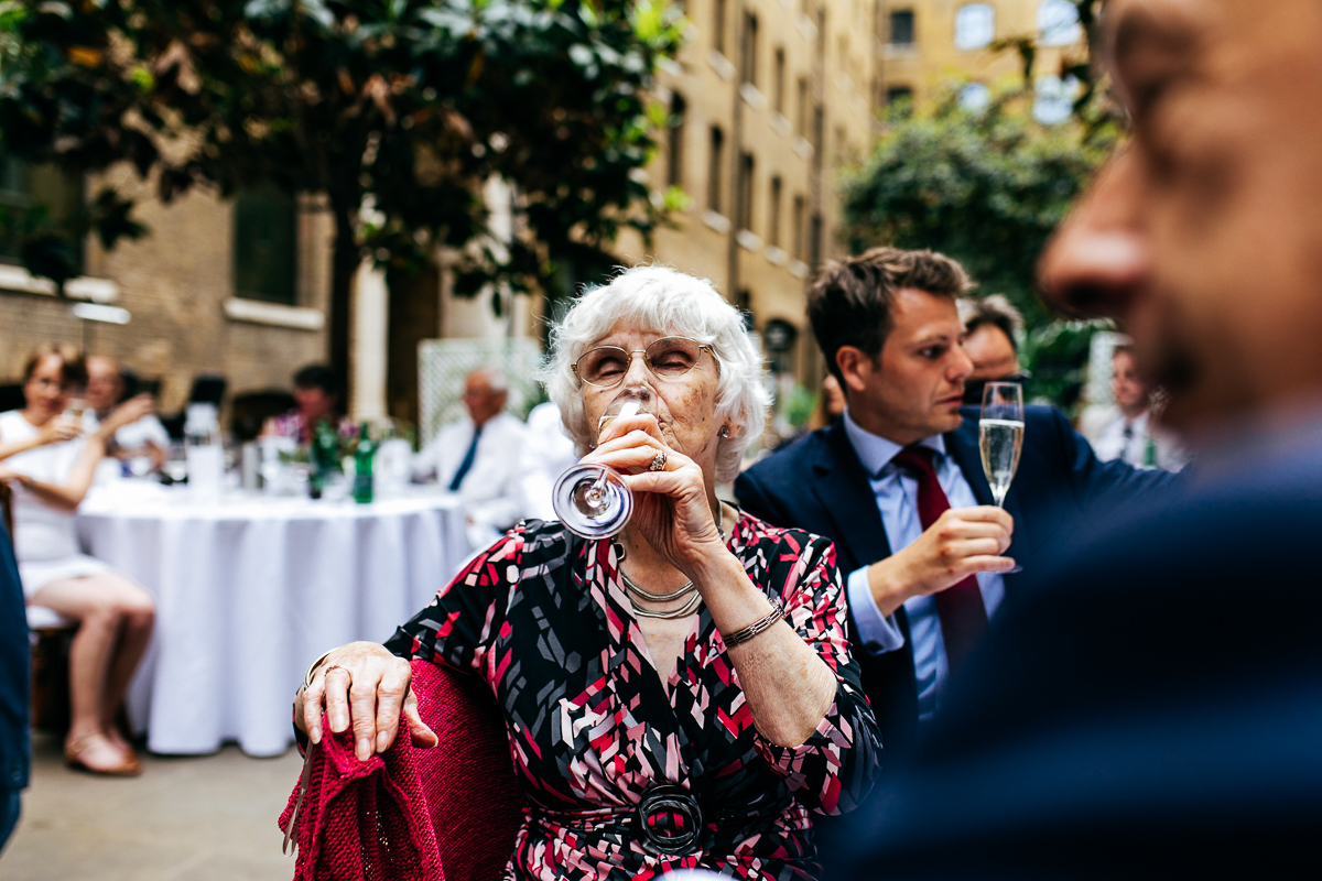 stylish-grandma-drinking-champagne-london-wedding-photographer